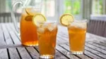 Picture of 2 glasses of iced tea with lemon along with a pitcher of iced tea