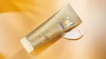 Dove Summer Revived lotion from Dove’s gradual tan range to give skin a summer glow. Product shown with amber background
