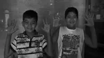 Two young boys showing their clean hands in India