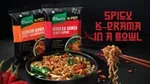 An image of red chopsticks lifting noodles from a bowl of Knorr Mini Meal noodles.