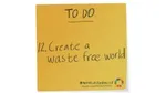 Mustard coloured sticky note with Create a waste free world written on it