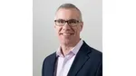 A photo of Steve McCrystal, Unilever Chief Enterprise and Technology Officer. He is a white man, wearing glasses, smiling at the camera